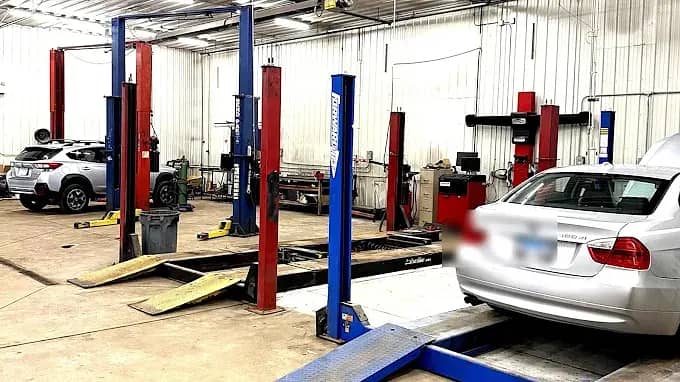 Service bays with vehicle lifts at R Complete Auto Care in Crown Point, IN